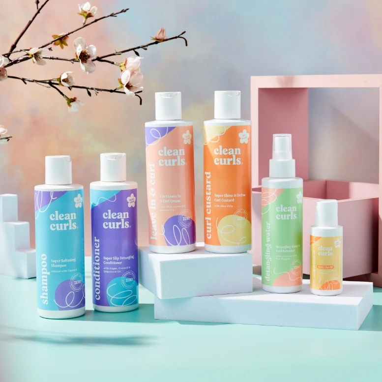A complete lineup of six hair and skin care bottles in pastel colors featuring Asikue font in use