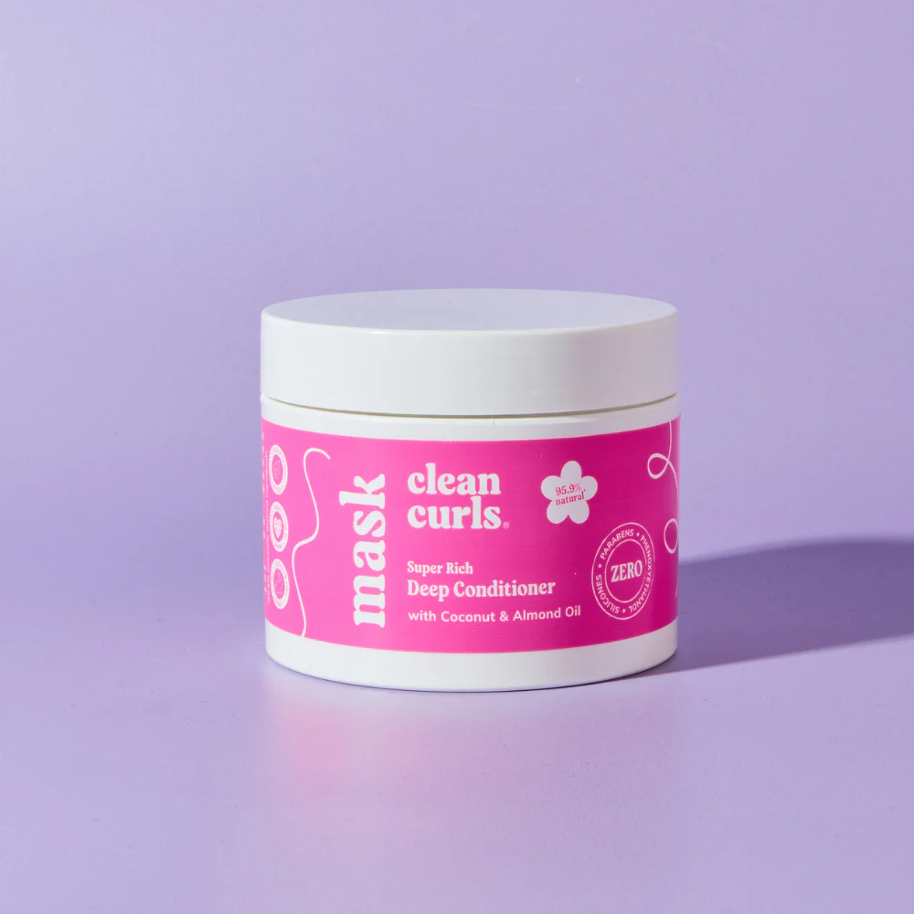 Single bottle of conditioner with a dollop of cream product on the side featuring Asikue font in use